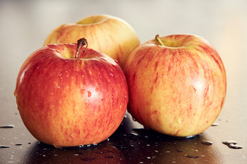 Three red apples on a white background