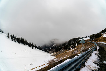 Scenic view of empty road with snow covered mountains and landscape in winter season.
