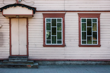 Walls and windows.The facade of the wooden house, door and windows