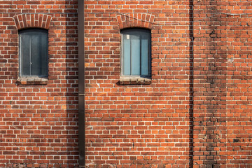 Walls and windows. Old brick wall with two windows.