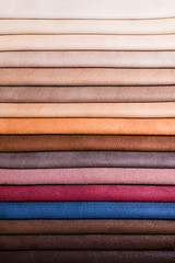 Colorful and bright fabric samples of furniture and clothing upholstery. Close-up of a palette of textile abstract stripes of different colors