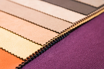 Colorful and bright fabric samples of furniture and clothing upholstery. Close-up of a palette of textile abstract stripes of different colors