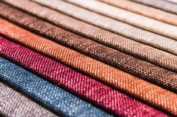 Close-up diagonal lines of textile upholstery in samples to select the color and fabric of the furniture. Abstract multicolored background