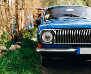 Obraz na płótnie Canvas Old blu luxury vintage russian car. volga 24. old antique car little bit rusty. shiny blue paint