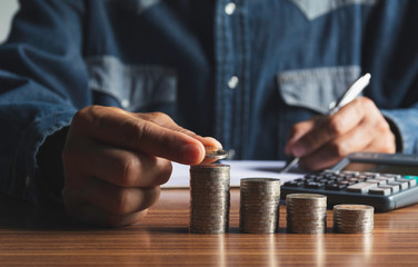 Hand drop a coin with money coin stack growing for business. financial and accounting concept.