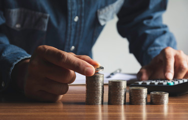 Hand drop a coin with money coin stack growing for business. financial and accounting concept.