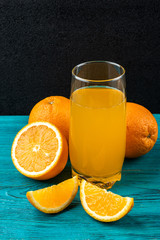 Orange juice on wooden background. 
