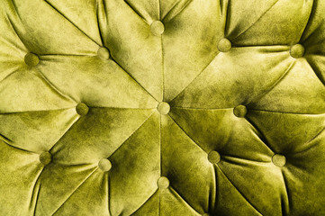 Velor lime surface of sofa close-up. Training equipment-velor mats tightened with buttons. Yellow chesterfield style quilted upholstery background