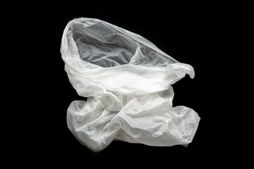 Plastic bag on a black background, isolate. Used plastic bag for recycling. Recycling of plastic waste into pellets as a business.