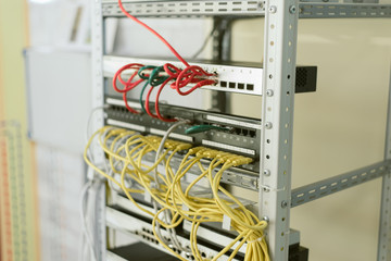 fiber optic in server room close up. Many wires connect to the network interfaces of powerful Internet servers.  Children's server equipment for games.