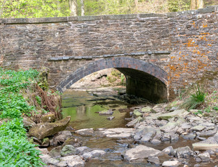 Fototapeta na wymiar View under old bridge over river