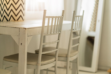 white vintage style wood table and chair with morning light from window