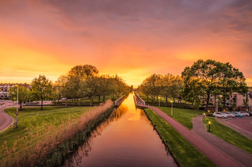 Fototapeta na wymiar Spectacular sunset over the Ringvaart (ring canal) in the Rotterdam suburb of Nieuwerkerk aan den Ijssel