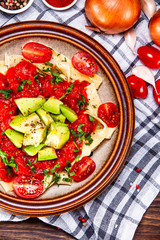 Pasta with herbs and vegetables on wooden background