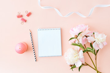 Mockup white notebook with light pink peonies on a pink background