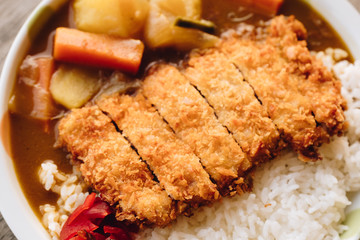 Rice with deep fried pork and curry in Japanese style or katsu kare in white plate ready to eat.