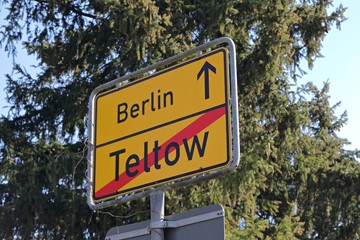 City of Berlin information road sign Teltow exit with a sunny blue sky background and trees