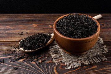 Black tea on dark wooden background. 