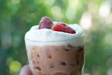 Chocolate drink with freeze strawberry put on milk foam
