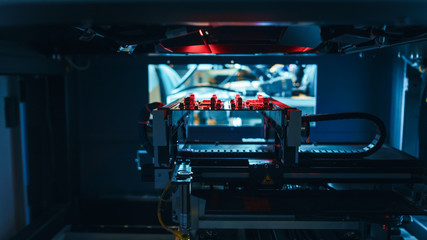 Automated Robotic Industrial Equipment is Testing Electronic Printed Circuit Board and Reject it with Red Light and Laser Technology After Assembly.