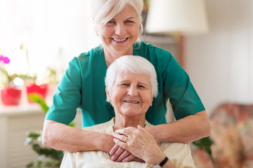 Home caregiver and senior adult woman