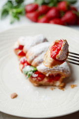 Croissant with strawberry and mint. On the for. Macro.