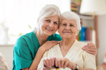 Home caregiver and senior adult woman