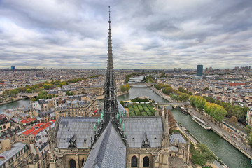 Fototapeta na wymiar Beautiful view of the city from a height, roof, statues and spire Cathedral of Notre Dame de Paris, France