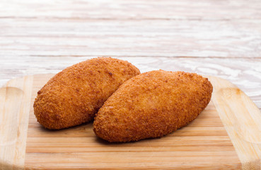 Kiev cutlets meat on wooden board