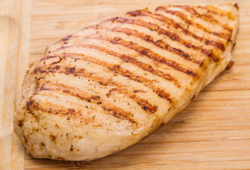 grilled chicken fillet on wooden