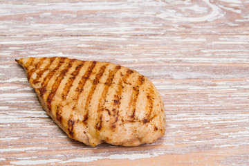 grilled chicken fillet on wooden