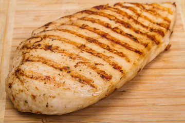 grilled chicken fillet on wooden