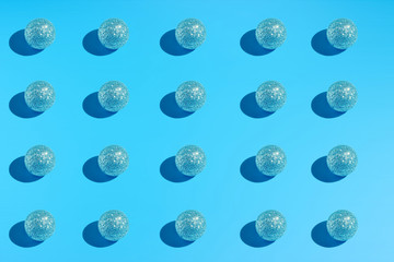 Symmetrically located blue christmas balls on a blue background