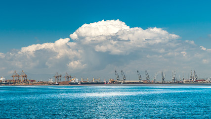 thessaloniki / Greece 11 April 2019 :heavy rain is approaching the city  the port and the industrial area of the city ,beautiful thermaik gulf in sunny day