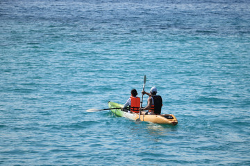 Men and women canoeing as sea activities.