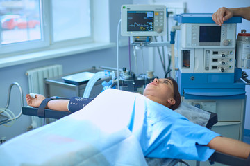 Several doctors surrounding patient on operation table during their work. Team surgeons at work in operating room