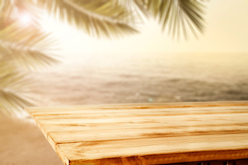 Obraz premium Desk of free space and summer landscape of sea beach and palms 