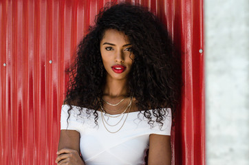 Black woman with red lips looking at camera