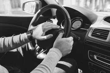 Close-up Of A Man Hands Holding Steering Wheel While Driving Car