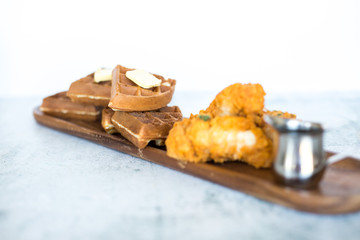 Chicken and Waffles on Wooden Plate 