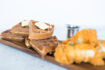 Chicken and Waffles on Wooden Plate 