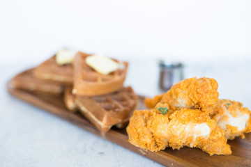 Chicken and Waffles on Wooden Plate 