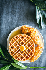 Chicken and Waffles with syrup and butter