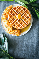 Chicken and Waffles with syrup and butter