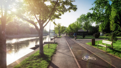 Man on bicycle park morning sunrise health exercise on park