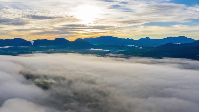 Beautiful aerial hyperlapse of misty morning above tea plantation with moving clouds and fog in Bandung, West Java, Indonesia. Shot in 4k resolution from a drone