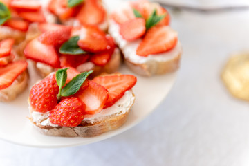 New trendy appetizers on the holiday table with fresh flowers and cheese.