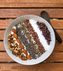 View of a great bowl with nuts and seeds. Basis is oat porridge.
