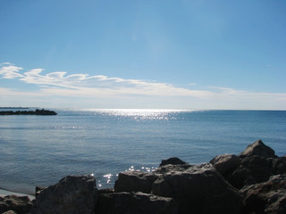 The sun reflects and glitters in the blue sea on the horizon.