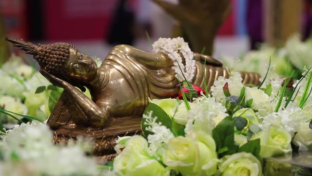 RACK FOCUS shot of a golden buddhist statue in Thailand.